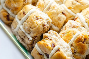 A tray of pastries with a white cross on top