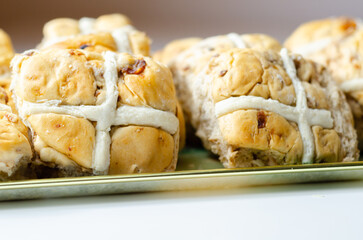 A tray of pastries with a white cross on top