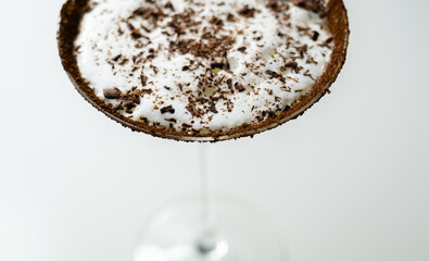 A chocolate martini is poured into a martini glass
