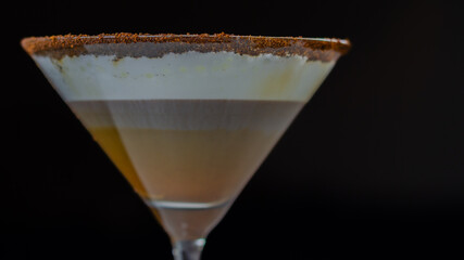 A chocolate martini is poured into a martini glass