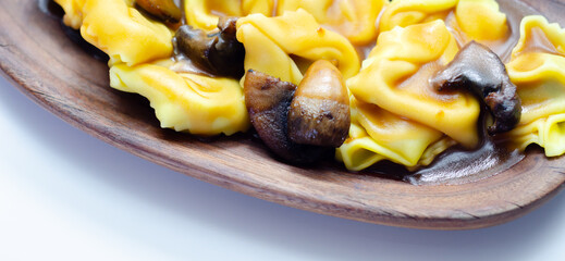 A plate of pasta with mushrooms and cheese