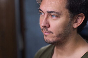 A man with makeup being applied, showing a closeup of the process focusing on his eyebrows