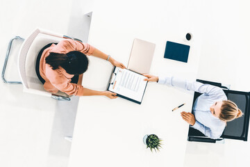 Two young business women in meeting at office table for job application and business agreement....