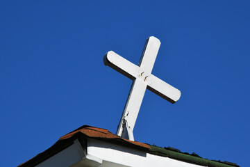 Cross Leans on Old Church
