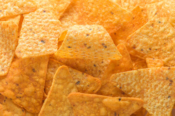 Pile of corn tortilla chips or nachos background
