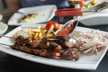 delicious shashlik on a plate with garnish and sauce
