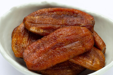 Sun dried bananas on white background.