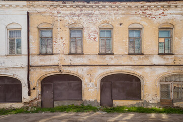 Fototapeta premium the facade of an old leaning brick building