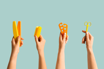 Female hands with supplies for pedicure on blue background
