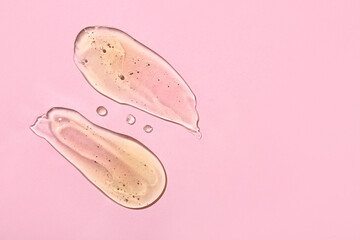 Samples of cosmetic gel on pink background