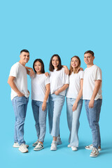 Group of young people in stylish jeans on blue background