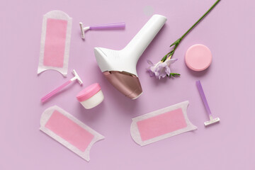 Modern photoepilator with wax strips, razors and jars of cream on purple background