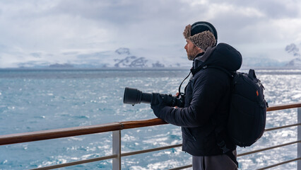 Handsome Professional Photographer Antarctica Cruise Ship With Telephoto Lens and Camera Bag Looks...