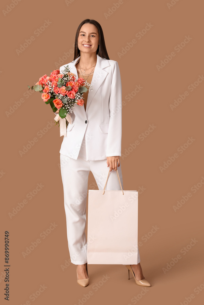 Canvas Prints Young woman with bouquet of beautiful flowers and shopping bag on brown background