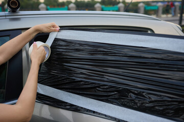 In an emergency, cover broken car window with duct tape for a quick roadside fix