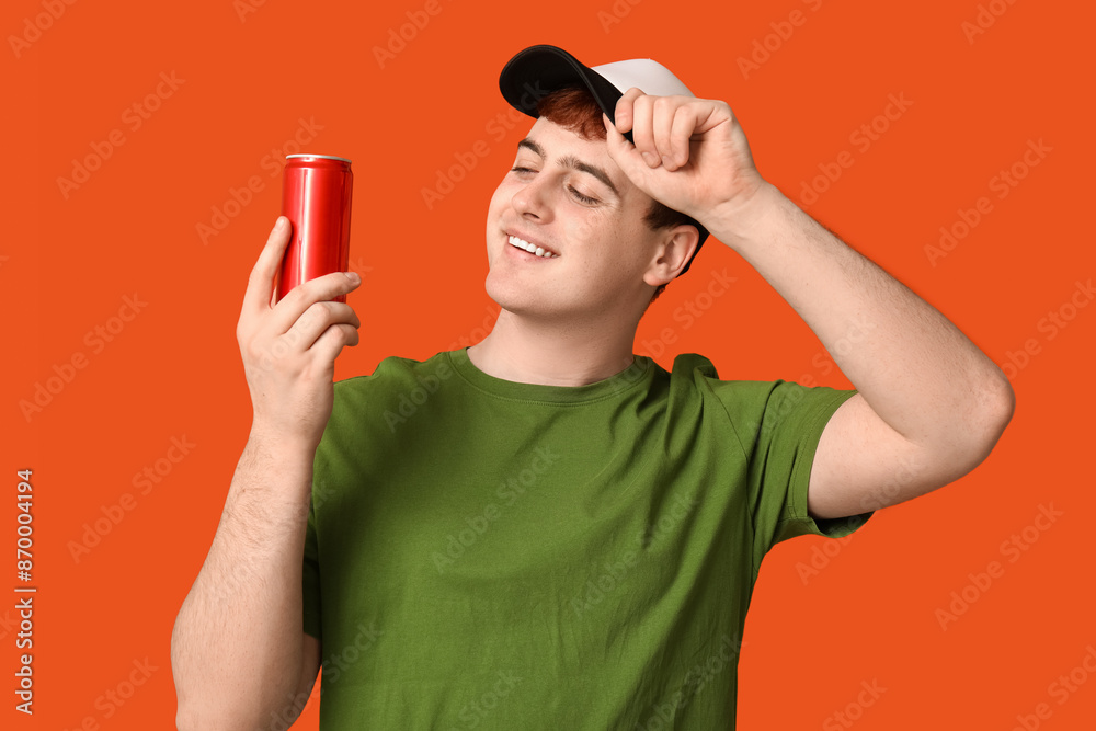 Sticker young man with can of soda on orange background