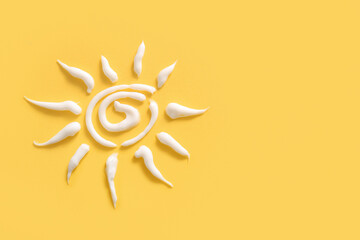 Sun made of sunscreen cream on yellow background