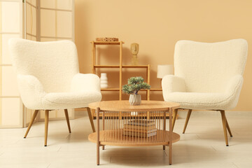 Stylish interior of modern living room with comfortable armchairs