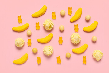 Colorful jelly bears and sweets on pink background