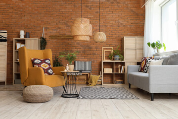 Armchair with cushion, cozy sofa and coffee table in living room