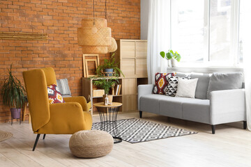 Armchair and sofa in interior of living room