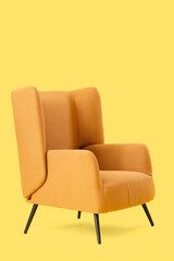 Brown armchair on yellow background