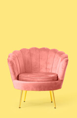 Pink armchair on yellow background