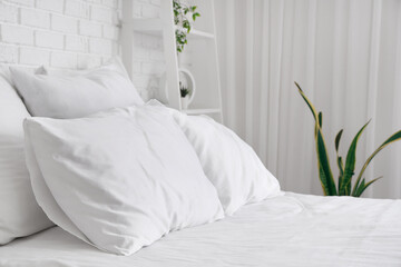 White pillows on comfortable bed in bedroom