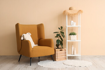 Armchair, rack and wicker box in interior of living room
