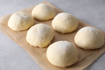 Raw dough balls on light grey table
