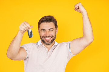 Excited Businessman with key. Real estate agent hold keys isolated on yellow. Real estate man hold keys. Broker or real estate agent with keys. Business man in t-shirt show keys. Car Key or house Key.