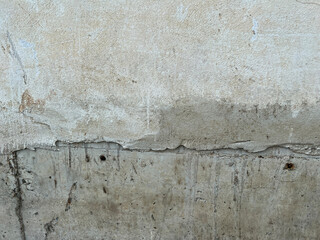 texture of a concrete wall with cracks and scratches which can be used as a background