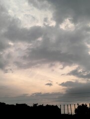 Cloudscape, Colored Clouds at Sunset near some buildings