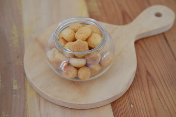 a traditional cake from Indonesia called kue sus filled with cream puffs. served on jar