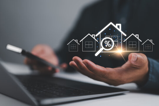 Real estate investment concept, Businessman use laptop with house icon for analyzing mortgage loan home and insurance real property mortgage. interest rate, Investment planning, business real estate.