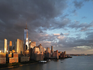 Obraz premium New York City top view. NYC aerial view, New York City Skyline with dramatic sky. Panoramic drone view on Manhattan in NY. Sunset in NYC. New York City Midtown skyline view at dusk with clouds.