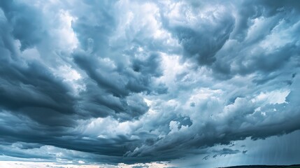 Obraz premium A sky filled with dark, ominous storm clouds, rumbling with distant thunder, evokes both fear and awe of nature's power.