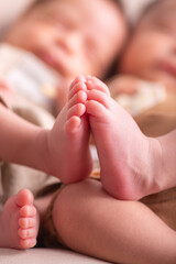 Little newborn baby human feet with toes and toenails close up