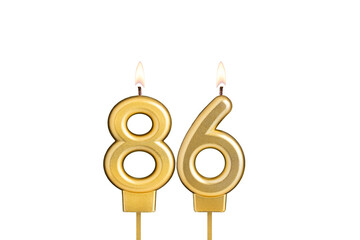 Birthday candle number 86 on white background