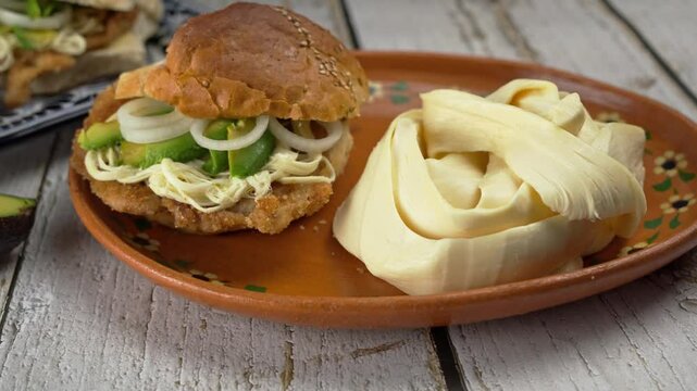 Mexican breaded steak cake on a gray wood table