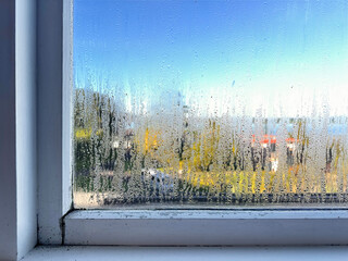 a wet humid window with condensation and mould 
