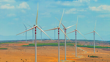 Windmill park with clouds and a blue sky, wind mill turbines in the ocean aerial view of a wind...