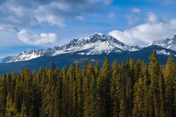 Cloudy Blue Sky Over Snow Capped Mountains