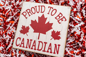 proud to be Canadian with maple leaf on wreath background