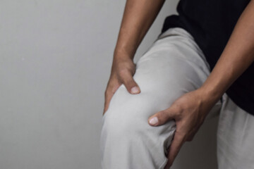 View of Man hand massage on knee for relief symptom in home with little blurry