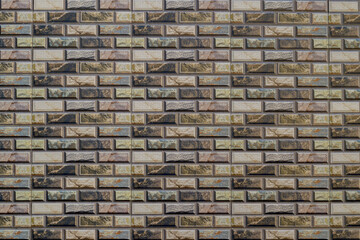 Obraz premium Tiled wall of ceramic with pattern motif in mixed color