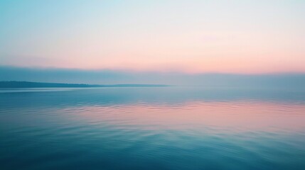 Fototapeta premium The calm waters of a lake at sunrise, with the sky painted in pastel colors, provide a perfect moment of serenity and reflection.