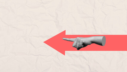 Antique statue hand pointing left direction following red arrow sign