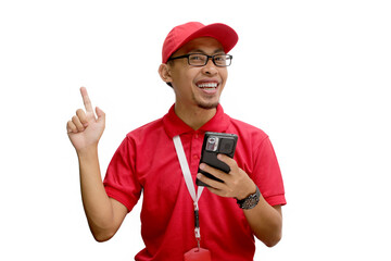 Excited Asian delivery man wearing eyeglasses or courier pointing to a phone with an empty white screen display, featuring copy space, isolated on a white background