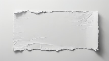 A single sheet of white paper with a torn edge on the left side lies on a white background. The blank sheet is slightly centered to create space for text.